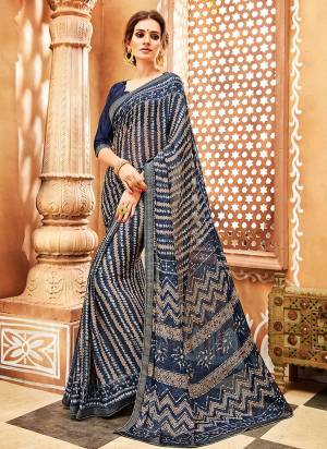 Here Is A Pretty Light Weight Saree Which Ensures You Superb Comfort For Casuals Or Semi-Casuals. This Saree Is Fabricated On Chiffon Georgette Paired With Soft Silk Fabricated Blouse. It Is Beautified with Prints All Over. 
