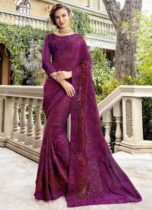 You Will Definitely Earn Lots Of Compliments Wearing This Heavy Designer Saree In Purple Color Paired With Purple Colored Blouse. This Saree And Blouse Are Silk Based Beautified With Heavy Embroidery Work All Over It.