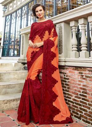 Get Ready For The Upcming Festive And Wedding Season With This Designer Saree In Peach And Maroon Color Paired With Maroon Colored Blouse. This Saree And Blouse Are Silk Based Beautified With Heavy Embroidery all Over. 
