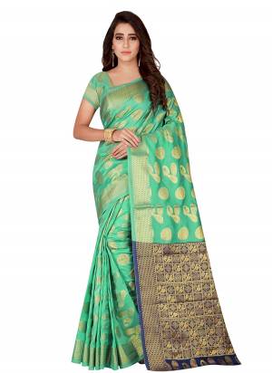 Simple, Elegant And Rich Looking Silk Based Saree Is Here In Sea Green And Navy Blue Color Paired With Sea Green Colored Blouse. This Saree And Blouse Are Fabricated On Kanjivaram Art Silk Beautified With Weave All Over It. 