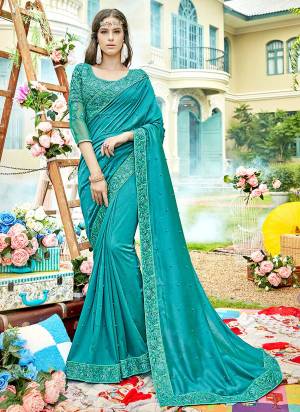 Here Is A Very Pretty Saree In Turquoise Blue Color Paired With Turquoise Blue Colored Blouse. This Saree Is Silk based Paired With Net And Art Silk Blouse Beautified With Heavy Embroidery.