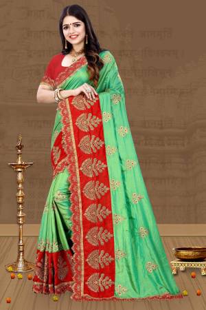 For A Proper Traditional Look, Grab This Designer Saree In Traditional Color Pallete With This Green Colored Saree Paired With Contrasting Red Colored Blouse. This Saree And Blouse Are Art Silk Based Beautified With Embroidery All Over. 