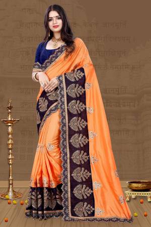For A Proper Traditional Look, Grab This Designer Saree In Traditional Color Pallete With This Light Orange Colored Saree Paired With Contrasting Navy Blue Colored Blouse. This Saree And Blouse Are Art Silk Based Beautified With Embroidery All Over. 
