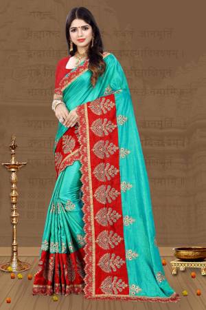 Celebrate This Festive Season Wearing This Beautiful Designer Saree In Turquoise Blue Color Paired With Contrasting Red Colored Blouse. This Saree And Blouse Are Fabricated On Art Silk Beautified With Heavy Embroidery, Buy Now.