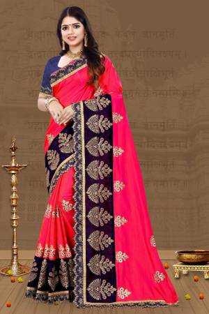 For A Proper Traditional Look, Grab This Designer Saree In Traditional Color Pallete With This Fuschia Pink Colored Saree Paired With Contrasting Navy Blue Colored Blouse. This Saree And Blouse Are Art Silk Based Beautified With Embroidery All Over. 