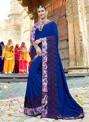 Shine Bright In This Designer Royal Blue Colored Saree Paired With Multi Colored Blouse. This Saree Is Silk Based Beautified With Heavy Embroidery Paired With Silk Based Printed Blouse. 
