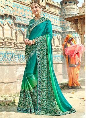 Adorn The Pretty Angelic Look Wearing This Designer Saree In Turquoise Blue Color Paired With Sea Green Colored Blouse. This Saree Is Fabricated On Silk Georgette With Embroiderey Paired With Printed Art Silk Fabricated Blouse. 