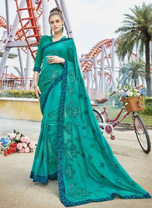 A Must Have Shade In Every Womens Wardrobe Is Here With This Designer Saree In Turquoise Blue Color Paired With Turquoise Blue Colored Blouse. This Saree Is Satin Silk Based Paired With Art Silk Blouse. 