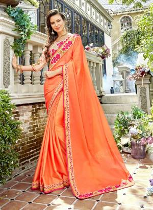 Orange Color Induces Perfect Summery Appeal To Any Outfit, So Grab This Designer Saree In Orange Color Paired With Light peach Colored Blouse. This Saree Is Fabricated On Satin Georgette Paired With Art Silk Fabricated Blouse. 