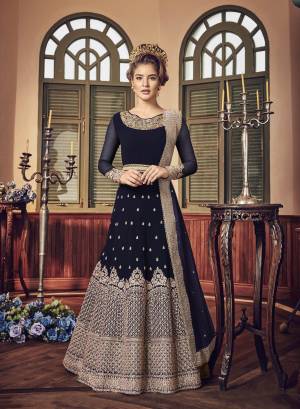A Must Have Shade In Dark Is Here With This Heavy Designer Floor Length Suit In Navy Blue Color Paired With Navy Blue Colored Bottom And Dupatta. Its Long Heavy Top Is Georgette Based Paired With Santoon Bottom And Chiffon Dupatta. It Has Heavy Jari Embroidery Giving A Rich And Elegant Look To The Suit.