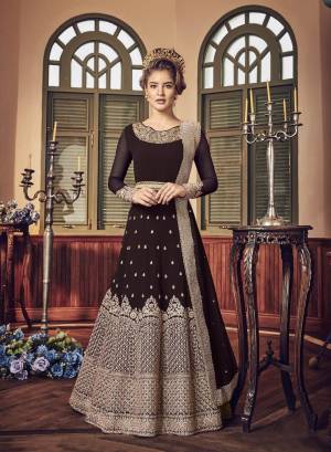 A Must Have Shade In Dark Is Here With This Heavy Designer Floor Length Suit In Dark Brown Color Paired With Dark Brown Colored Bottom And Dupatta. Its Long Heavy Top Is Georgette Based Paired With Santoon Bottom And Chiffon Dupatta. It Has Heavy Jari Embroidery Giving A Rich And Elegant Look To The Suit.