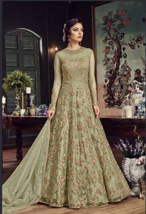 Look The Most Prettiest Of All Wearing This Heavy Designer Floor Length Suit In Mint Green Color Paired With Mint Green Colored Bottom And Dupatta. Its Top And Dupatta Are Net Fabricated Paired With Santoon Bottom. Buy Now.