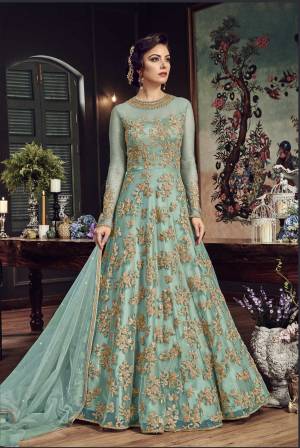 Look The Most Prettiest Of All Wearing This Heavy Designer Floor Length Suit In Aqua Blue Color Paired With Aqua Blue Colored Bottom And Dupatta. Its Top And Dupatta Are Net Fabricated Paired With Santoon Bottom. Buy Now.