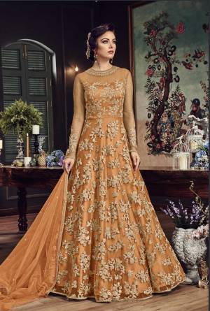 Look The Most Prettiest Of All Wearing This Heavy Designer Floor Length Suit In Orange Color Paired With Orange Colored Bottom And Dupatta. Its Top And Dupatta Are Net Fabricated Paired With Santoon Bottom. Buy Now.
