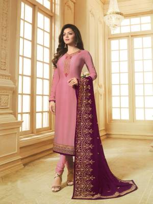 Look Pretty In This Designer Straight Suit In Pink Color Paired With Contrasting Purple Colored Dupatta. Its Embroidered Top Is Georgette Satin Based Paired With Santoon Bottom And Georgette Dupatta. All Its Fabric Are Light Weight And Easy To Carry All Day Long.