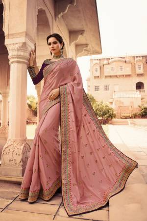 Look The Most Prettiest Of all Wearing This Designer Saree In Dusty Pink Color Paired With Contrasting Wine Colored Blouse. This Saree Is Fabricated On Soft Silk Paired With Art Silk Fabricated Blouse. Its Saree And Blouse Are Beautified With Heavy Embroidery Work. 