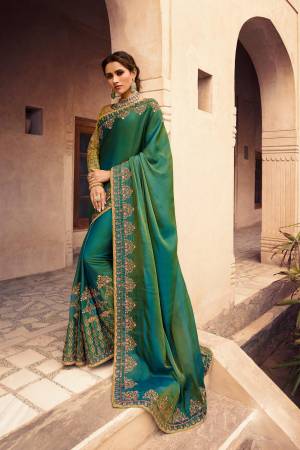 Celebrate This Festive And Wedding Season Wearing This Designer Saree In Green Color Paired With Pear Green colored Blouse. This Saree Is Fabricated On soft Silk Paired With Art Silk Fabricated Blouse. 