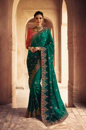 Grab This Designer Bright Colored Saree In Dark Teal Green Color Paired With Contrasting Pink Colored Blouse. This Saree Is Soft Silk Based Paired With Art Silk Fabricated Blouse. It Has Attractive Embroidery All Over. Buy Now.