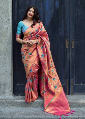 Add This Pretty Amazing Silk Based Saree In Dark Peach Color Paired With Contrasting Sky Blue Colored Blouse. This Saree And Blouse Are Fabricated On Kanjivaram Art Silk Beautified With Weave All Over. 