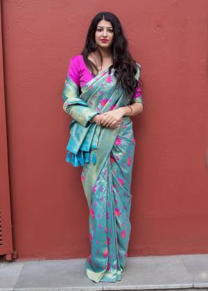Grab This Pretty Shade In Blue With This Silk based Saree In Sky Blue Color Paired With Contrasting Rani Pink Colored Blouse. This Saree And Blouse Are Fabricated On Kanjivaram Art Silk Beautified With Weave All Over It. 