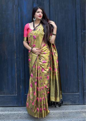 Must Have Shade In Every Womens Wardrobe Is Here With This Saree In olive Green Color Paired With Contrasting Dark Pink Colored Blouse, This Saree And Blouse Are Fabricated On Kanjivaram Art Silk Beautified With Weave. 
