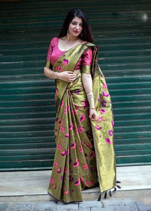 Must Have Shade In Every Womens Wardrobe Is Here With This Saree In olive Green Color Paired With Contrasting Dark Pink Colored Blouse, This Saree And Blouse Are Fabricated On Kanjivaram Art Silk Beautified With Weave. 