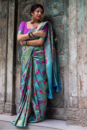 Grab This Pretty Shade In Blue With This Silk based Saree In Sky Blue Color Paired With Contrasting Purple Colored Blouse. This Saree And Blouse Are Fabricated On Kanjivaram Art Silk Beautified With Weave All Over It. 