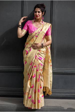 Simple And Elegant Looking Designer Silk Saree Is Here In Cream Color Paired With Pink Colored Blouse. This Saree And Blouse Are Fabricated On Kanjivaram Art Silk Beautified With Weave All Over . 
