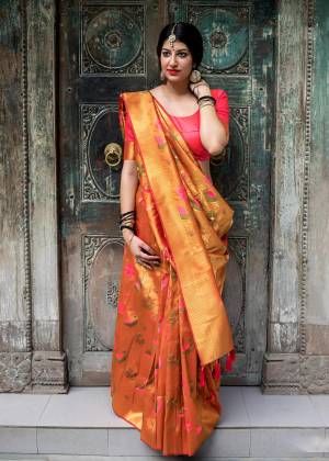 Celebrate This Festive Season With This Designer Silk Based Saree In Orange Color Paired With Contrasting Fuschia Pink Colored Blouse. This Saree And Blouse Are Fabricated On Kanjivaram Art Silk Beautified With Weave. 