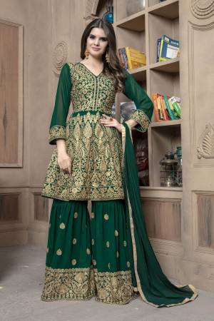 Here Is A Designer Sharara Dress In Dark Green For This Wedding And Festive Season.Its Top And Bottom Are Georgette Based Paired With Chiffon Fabricated Dupatta. Both Its Top And Bottom Are Beautified With Heavy Jari Embroidery And Stone Work.Buy This Semi-Stitched Suit Now.
