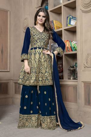Here Is A Designer Sharara Dress In Navy Blue For This Wedding And Festive Season.Its Top And Bottom Are Georgette Based Paired With Chiffon Fabricated Dupatta. Both Its Top And Bottom Are Beautified With Heavy Jari Embroidery And Stone Work. Buy This Semi-Stitched Suit Now.