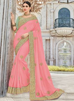 Attractively Gorgeous mesmerizing is what you will look at the next wedding gala wearing this beautiful Pink color silk fabrics saree. Ideal for party, festive & social gatherings. this gorgeous saree featuring a beautiful mix of designs. Its attractive color and designer heavy embroidered design, Flower patch design, beautiful floral design work over the attire & contrast hemline adds to the look. Comes along with a contrast unstitched blouse.