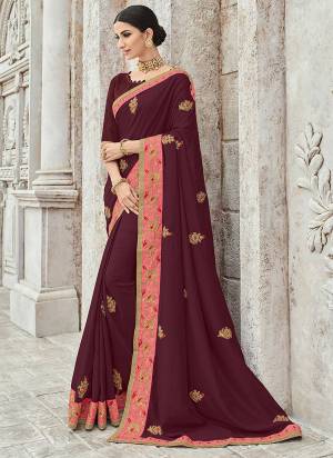 Look your ethnic best by wearing this maroon color silk fabrics saree. Ideal for party, festive & social gatherings. this gorgeous saree featuring a beautiful mix of designs. Its attractive color and designer heavy embroidered design, Flower zari design, stone design, beautiful floral design work over the attire & contrast hemline adds to the look. Comes along with a contrast unstitched blouse.
