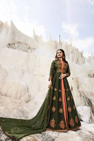 New And Unique Color Pallete Is Here With This Designer Indo Western Suit In Dark Olive And Peach Color Paired With Peach Colored Bottom And Dark Olive Green Dupatta. Its Top Is silk Based Paired With Santoon Bottom And Georgette Dupatta. 