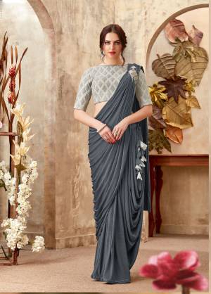 Look simple and sombre with this grey cowl saree. Blouse entrails the heavy embroidery of cord and pearls. 