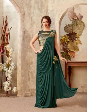 Pine green is the new red for Indian occasions. The golden sequins blouse makes it blockbuster for the season. 