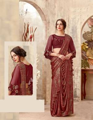 Be ready to evoke a storm of envy at any Indian occasion with this maroon-gold draped saree. Let your look get dual attention with the bell sleeved blouse. 