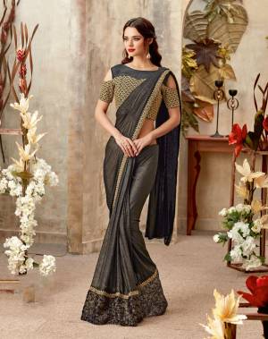 Look sensual and modern in this golden shimmery black saree,. Keep the jewelry minimal for added elegance. 