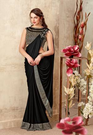 Walk out in this exquisite black saree with style and a never-like before panache . Add bold , geometrical motif jewels for an added style. 