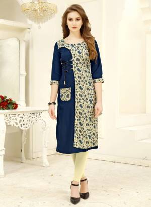 Add This Lovely Kurti To Your Wardrobe In Blue And Cream Color Fabricated on Rayon. It Has Pretty Floral Prints. Buy Now.