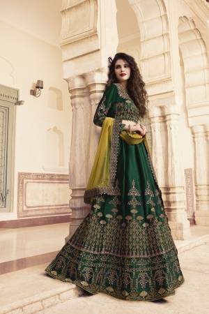 Go With The Lovely Shades Of Green With This Designer Lehenga Choli In Pine Green Color Paired With Contrasting Pear Green Colored Dupatta. Its Blouse And Lehenga Are Fabricated On Soft Silk Paired With Net Fabricated Dupatta. 