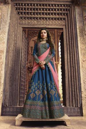Pretty Combination Is Here With This Designer Lehenga Choli In Blue Color Paired With Contrasting Pink Colored Dupatta. Its Blouse And Lehenga Are Silk Based Paired With Net Fabricated Dupatta. 