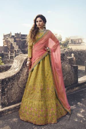 New And Unique Shade In Here To Add Into Your Wardrobe With This Designer Lehenga Choli In Pear Green Color Paired With Contrasting Pink Colored Dupatta. It Is Soft Silk Based Paired With Net Dupatta. 