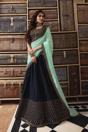 Quite Different Pattern Is Here In lehenga Choli Which You Can Wear In Two Ways. Its Blouse , Lehenga And Pant Are In Navy Blue Color Paired With Aqua Blue Colored Dupatta And Jacket. Its Blouse Is Art Silk Fabricated Paired With Silk Georgette Lehenga And Net Dupatta. Also It HAs Soft Silk Based pants And Orgenza Fabricated Jacket. Grab It Now.