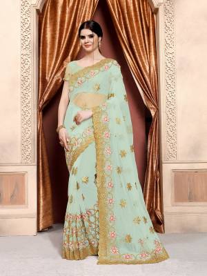 Grab This Pretty Subtle Shade Saree In Aqua Blue Color Paired With Aqua Blue Colored Blouse. This Saree And Blouse Are Fabricated On Net Beautified With Heavy Jari And Thread Embroidery With Stone Work. 
