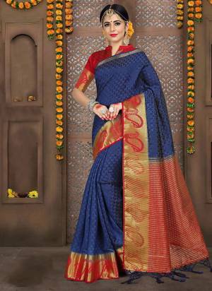 Grab This Pretty Silk Based Saree In Navy Blue Color Paired With Contrasting Red Colored Blouse. This Saree And Blouse Are Fabricated On Embossed Jacquard Beautified With Weave All Over. 