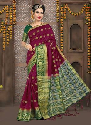 Add This Pretty Saree To your Wardrobe In Magenta Pink Color Paired With Contrasting Dark Green Colored Blouse. This Saree And Blouse Are Fabricated On Art Silk Beautified With Weave. 