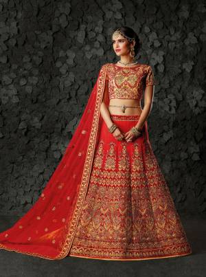 A Very Pretty Bridal Collection Is Here With This Designer Lehenga Choli In Beige Colored Blouse Paired With Red Colored Lehenga And Dupatta. Its Blouse And Lehenga Are Silk Based Paired With Net Fabricated Dupatta. It Is Beautified With Heavy Emnbroidery All Over. 