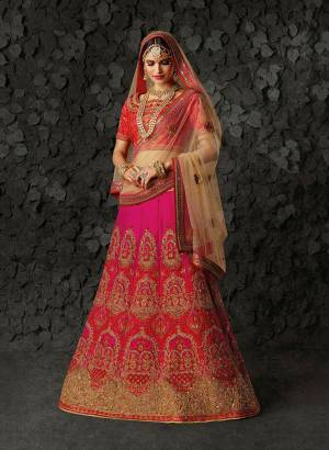 Go Colorful With This Heavy Designer Lehenga Choli In Red Colored Blouse paired With Fuschia Pink Colored Lehenga And Beige Colored Dupatta. This Heavy Embroidered Lehenga Choli Is Silk Based Paired With Net Fabricated Blouse. Buy Now.