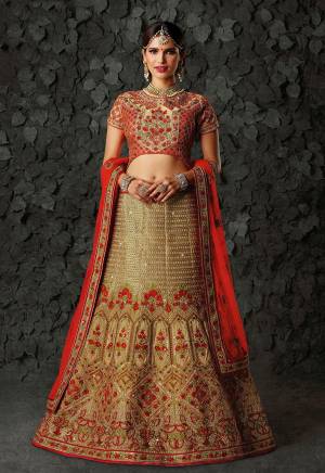 A Very Pretty Bridal Collection Is Here With This Designer Lehenga Choli In Beige Colored Blouse Paired With Red Colored Lehenga And Dupatta. Its Blouse And Lehenga Are Silk Based Paired With Net Fabricated Dupatta. It Is Beautified With Heavy Emnbroidery All Over. 